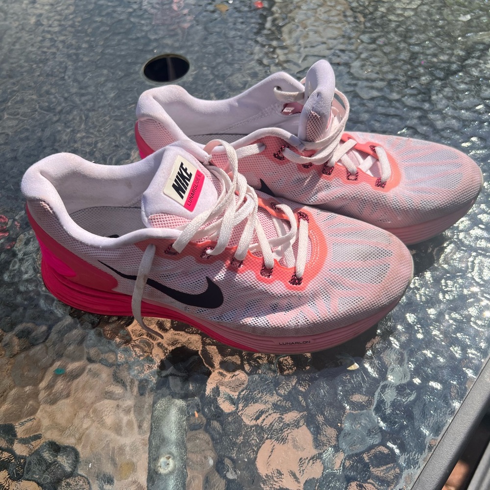 Nike Women's Pink, White and Black athletic sneakers.